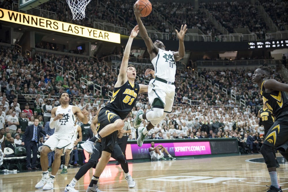 Lourawls 'Tum Tum' Nairn Jr. shoots the ball as he is defended by Iowa forward Nicholas Baer during the second half of men's basketball game against Iowa on Feb. 11, 2017 at Breslin Center. The Spartans defeated the Hawkeyes, 77-66.
