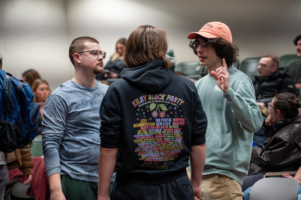 Joe Lorenz, a senior journalism major, and Norberto Lamenca, a senior majoring in environmental economics and management, talks with their friend before the start of an Outdoors Club meeting at IM West Recreational Facility in East Lansing, Mich., on Monday, Feb. 9, 2026. Lamenca said the club has been his main social outlet at Michigan State, while Lorenz said it gave him a consistent group to explore the outdoors with.