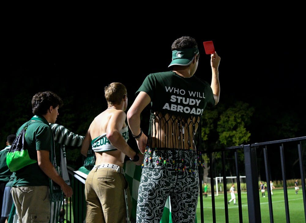 Senior international relations major and Red Cedar Rowdies member Eric Frey holds up a red card to Notre Dame players during the game at DeMartin field on September 24, 2019. The Spartans lost to the Fighting Irish 0-1. 