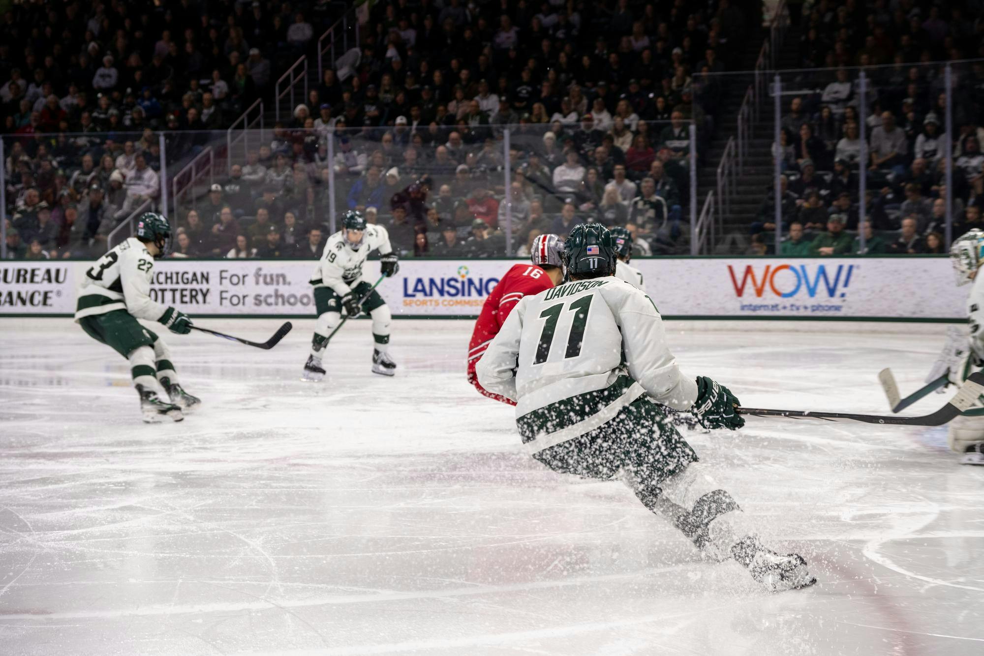 MSU Senior forward Jeremy Davidson #11 prevents a goal try by Ohio State Freshman forward Max Montes #16 at Munn Ice Arena on Feb. 23, 2024.