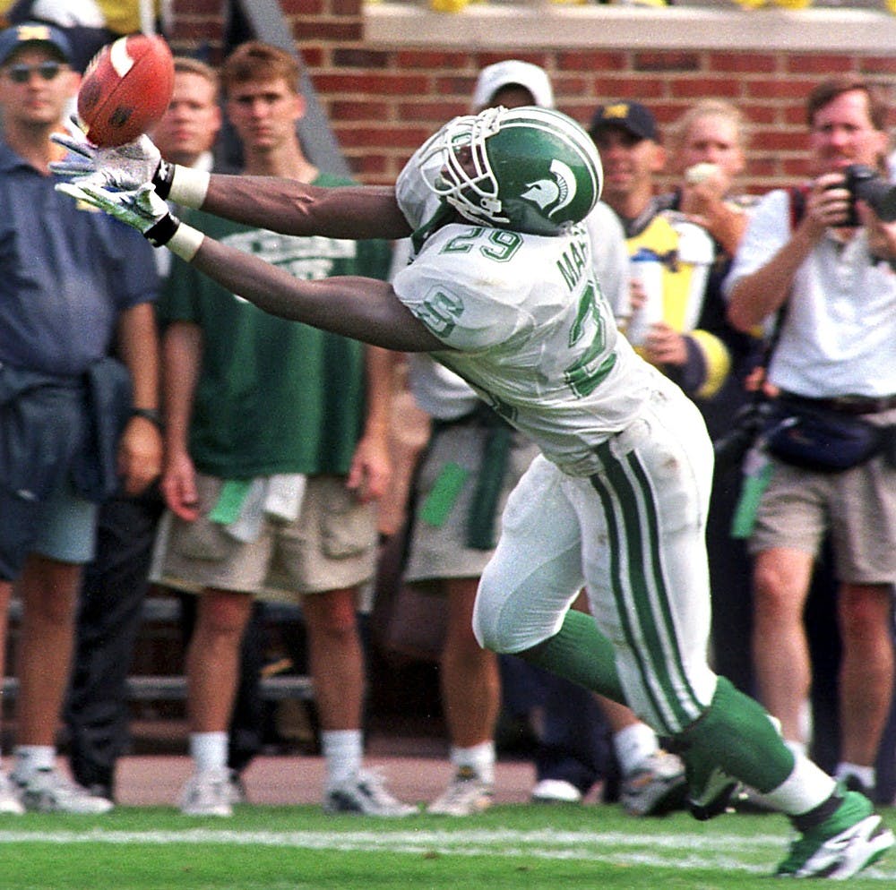 <p>Senior safety Lemar Marshall tries unsuccessfully for an interception in the Michigan end zone during the third quarter against Michigan on Sept. 26, 1998, at Michigan Stadium in Ann Arbor. The Spartans lost, 29-17. Cory Morse/The State News</p>