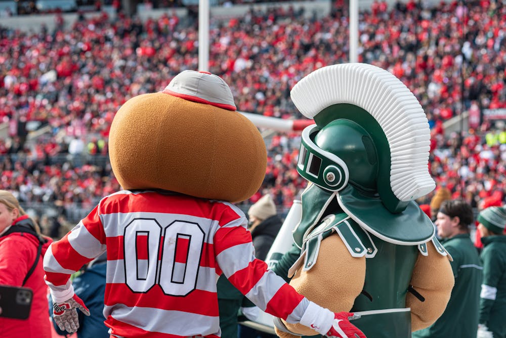 <p>Ohio State&#x27;s mascot Brutus Buckeye watches the game with Michigan State&#x27;s mascot Sparty on Nov. 20, 2021.</p>
