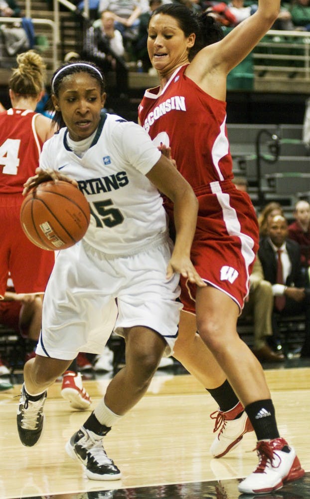 Senior forward Cetera Washington pushes past Wisconsin guard Taylor Wurtz Thursday at Breslin Center.  The Spartans defeated the Badgers, 62-43.  Katy Joe DeSantis/The State News    