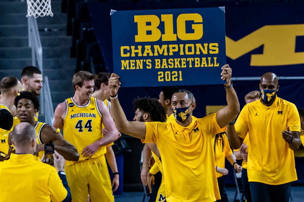 <p>Michigan coach Juwan Howard holds up a Big Ten champions sign after his team&#x27;s win against Michigan State. The Wolverines crushed the Spartans, 69-50, at Crisler Center on Mar. 4, 2021. </p>