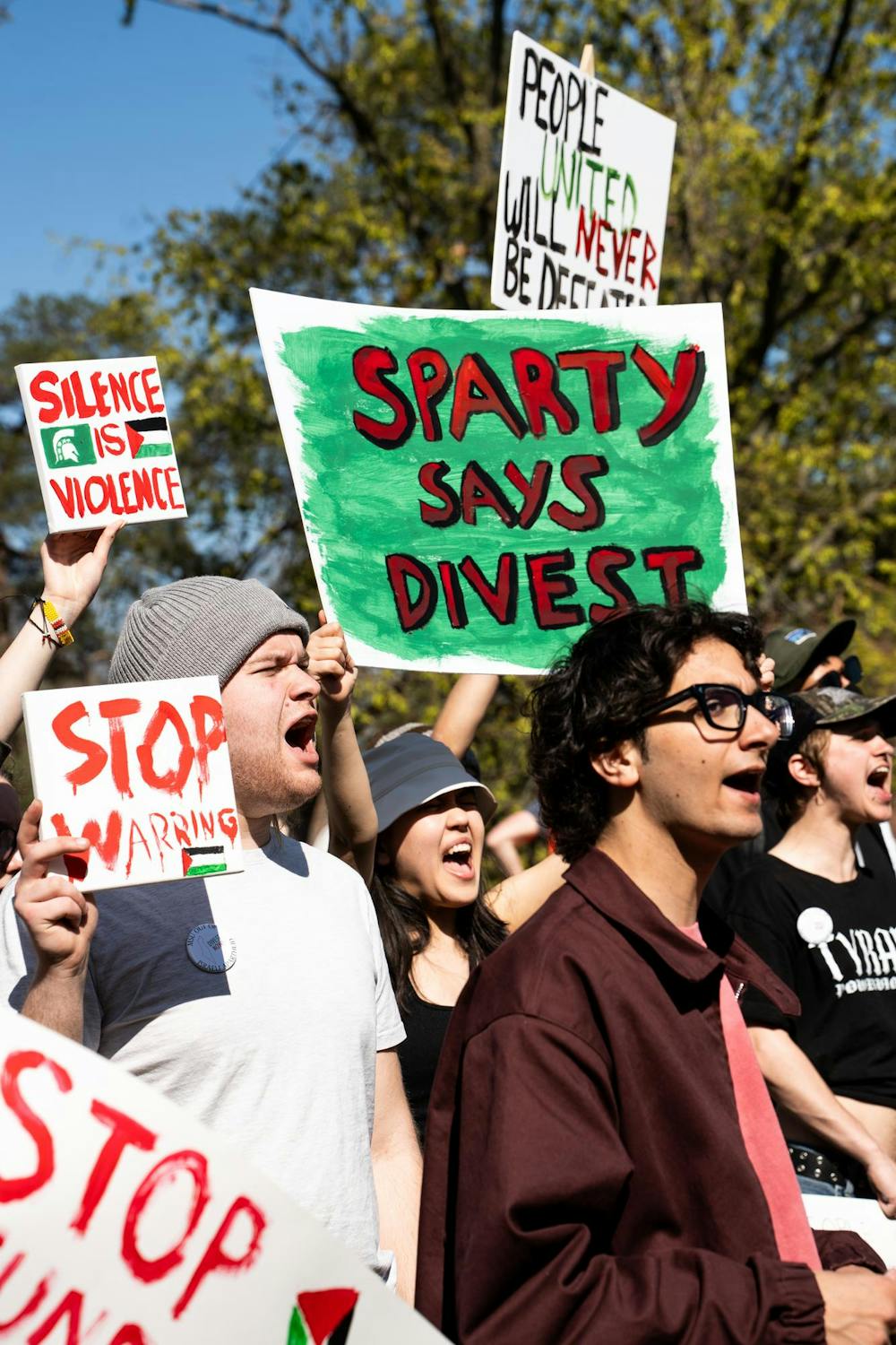 Michigan State University students and community members yell chants at the Gaza solidarity encampment in People’s Park on MSU’s campus on April 25, 2024.
