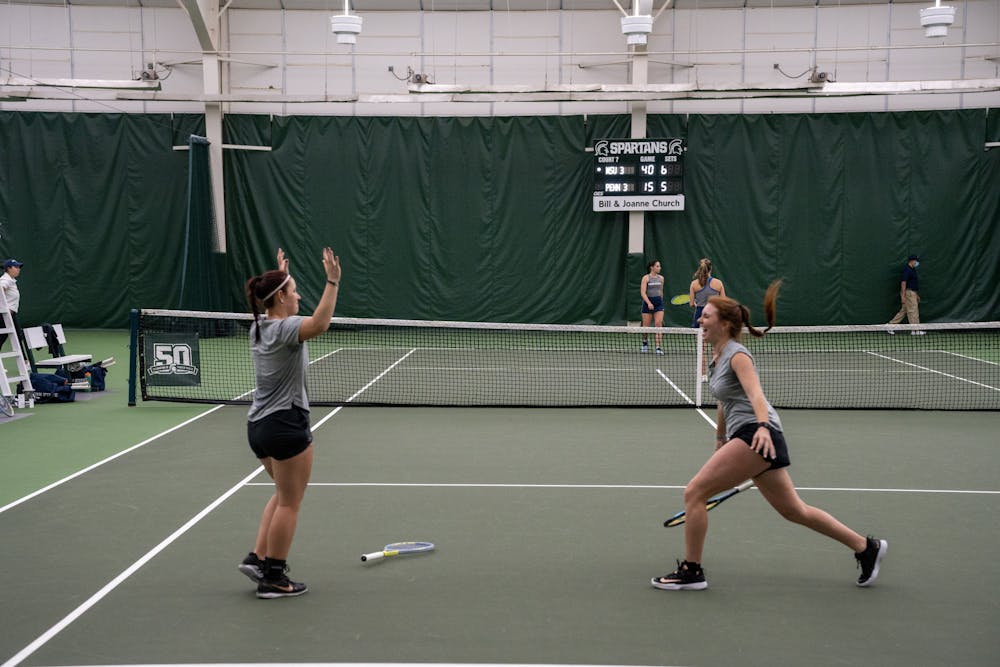 <p>Senior Dagmar Zdrubecka and freshman Juliette Nask celebrate during their doubles match against Penn State on April 16, 2023.</p>