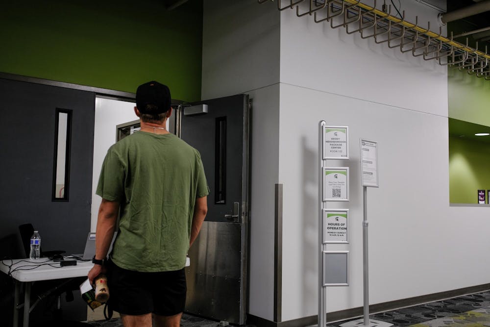 <p>An MSU student waits to pick up a package at Brody Hall on Sept. 6, 2023. Instead of delivering packages to the surrounding dorms, Brody Hall now requires students to pick up their packages themselves.</p>