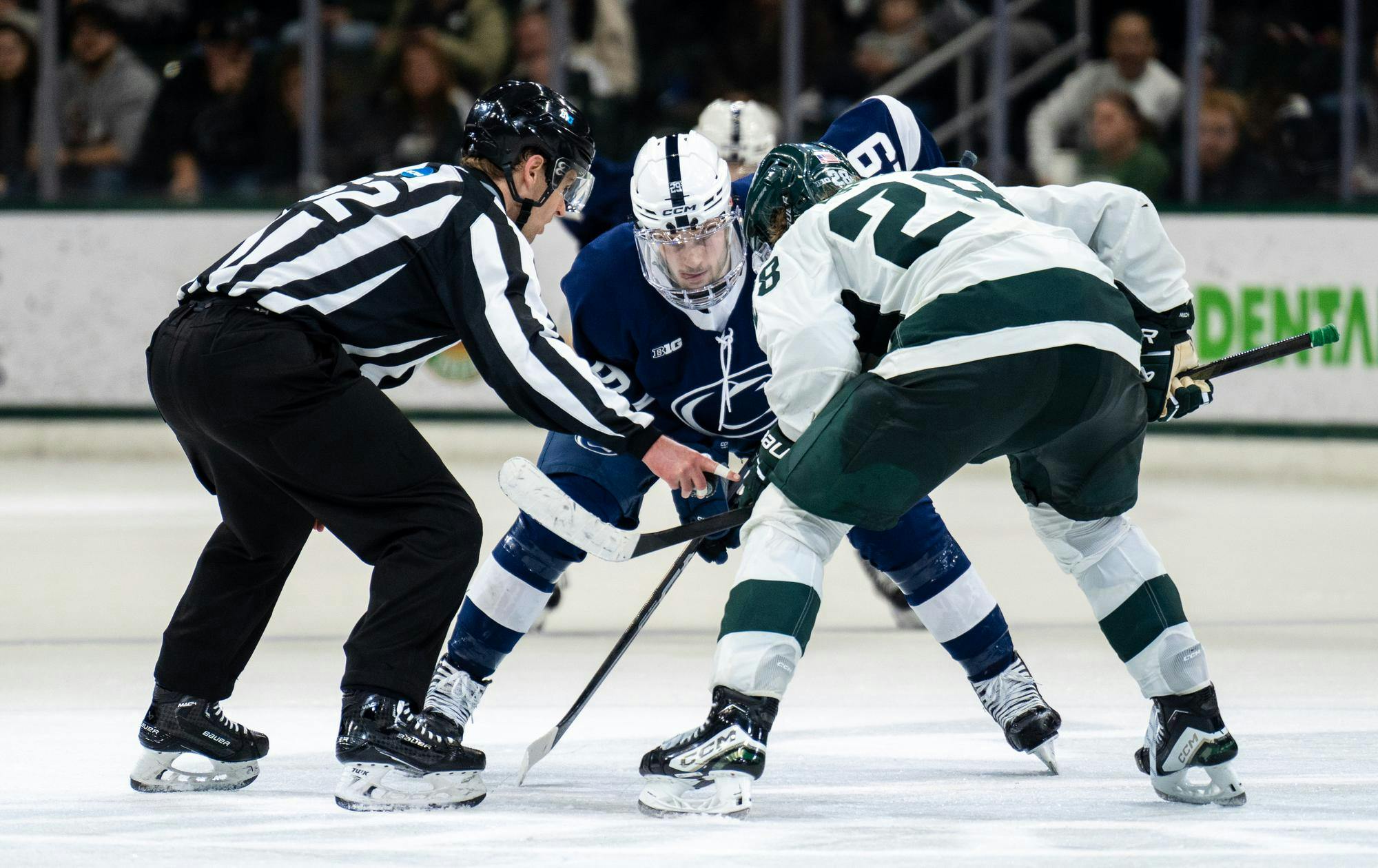 <p>Michigan State junior forward Karsen Dorwart (28) and Penn State sophomore forward Reese Laubach (29) take a face off at Munn Ice Arena on Feb. 22, 2025. The Spartans lost 3-2 to the Nittany Lions. </p>