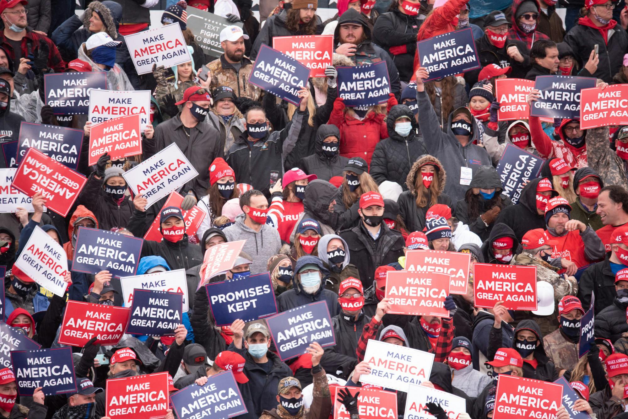 <p>Lansing Michigan Trump Rrally Participants holding Trump 2020 signs while waiting for the arrival of President Donald Trump on Tuesday, October 27, 2020. </p>