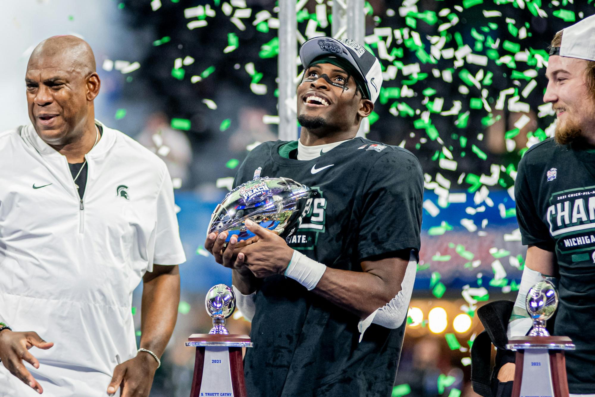 <p>Michigan State redshirt junior wide receiver Jayden Reed holds the Chick-fil-A Peach Bowl Trophy during post-game celebrations on Dec. 30, 2021. Reed caught the game-winning touchdown.</p>