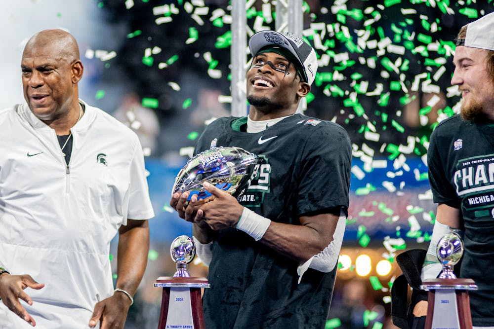 <p>Michigan State redshirt junior wide receiver Jayden Reed holds the Chick-fil-A Peach Bowl Trophy during post-game celebrations on Dec. 30, 2021. Reed caught the game-winning touchdown.</p>