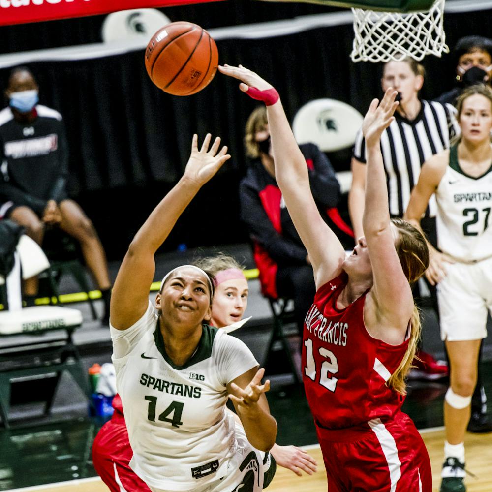 <p>Katie Dettwiller, number 12, blocks a shot from MSU&#x27;s Taiyier Parks, number 14, on Nov. 27, 2020.</p>