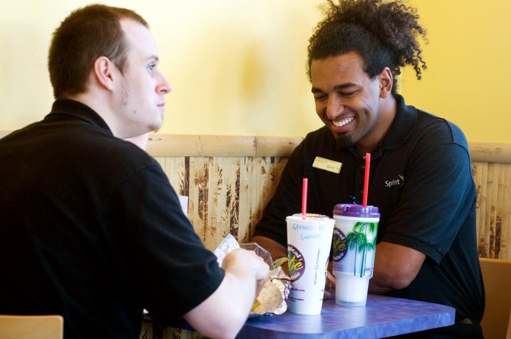 Lansing residents Jordan Wood, left, and Terence Wilkerson have smoothies Monday afternoon at Tropical Smoothie Cafe, 1201 E. Grand River Ave. Samantha Radecki/The State News