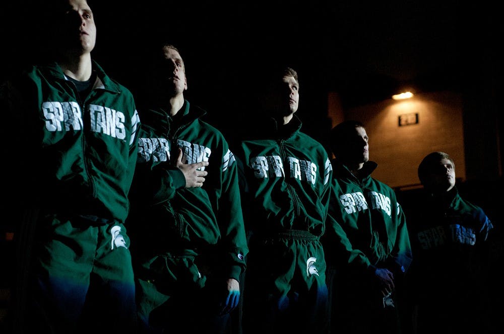 	<p>Members of the <span class="caps">MSU</span> Wrestling team stand for the singing of the national anthem by the Gracewood Singers on Friday, Jan. 4, 2013, at Jenison Field House. The Spartans were defeated 26-10 by Purdue University. Katie Stiefel/The State News</p>