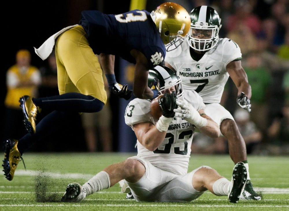 Junior linebacker Jon Reschke (33) intercepts a pass during the game against Notre Dame on Sept. 17, 2016 at Notre Dame Stadium in South Bend, Ind.  The Spartans defeated the Fighting Irish, 36-28. 