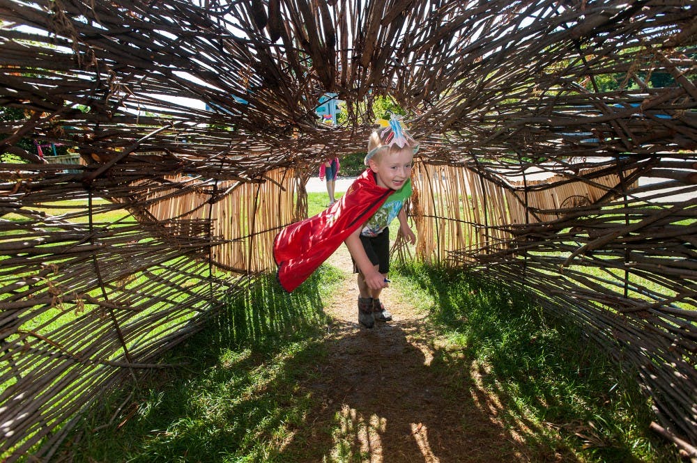 Minneapolis?Saint Paul, Minn. resident Liam Kirchner, 4, rushes into a tunnel on Tuesday morning, July 31, 2012 at 4-H Children's Garden during Bug Day. Justin Wan/The State News