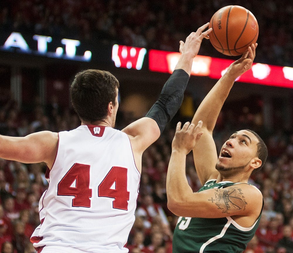 	<p>Sophomore guard Denzel Valentine attempts a shot over Wisconsin forward Frank Kaminsky on Feb. 9, 2014, at Kohl Center in Madison, Wis. The Spartans lost to the Badgers, 60-58. Danyelle Morrow/The State News</p>