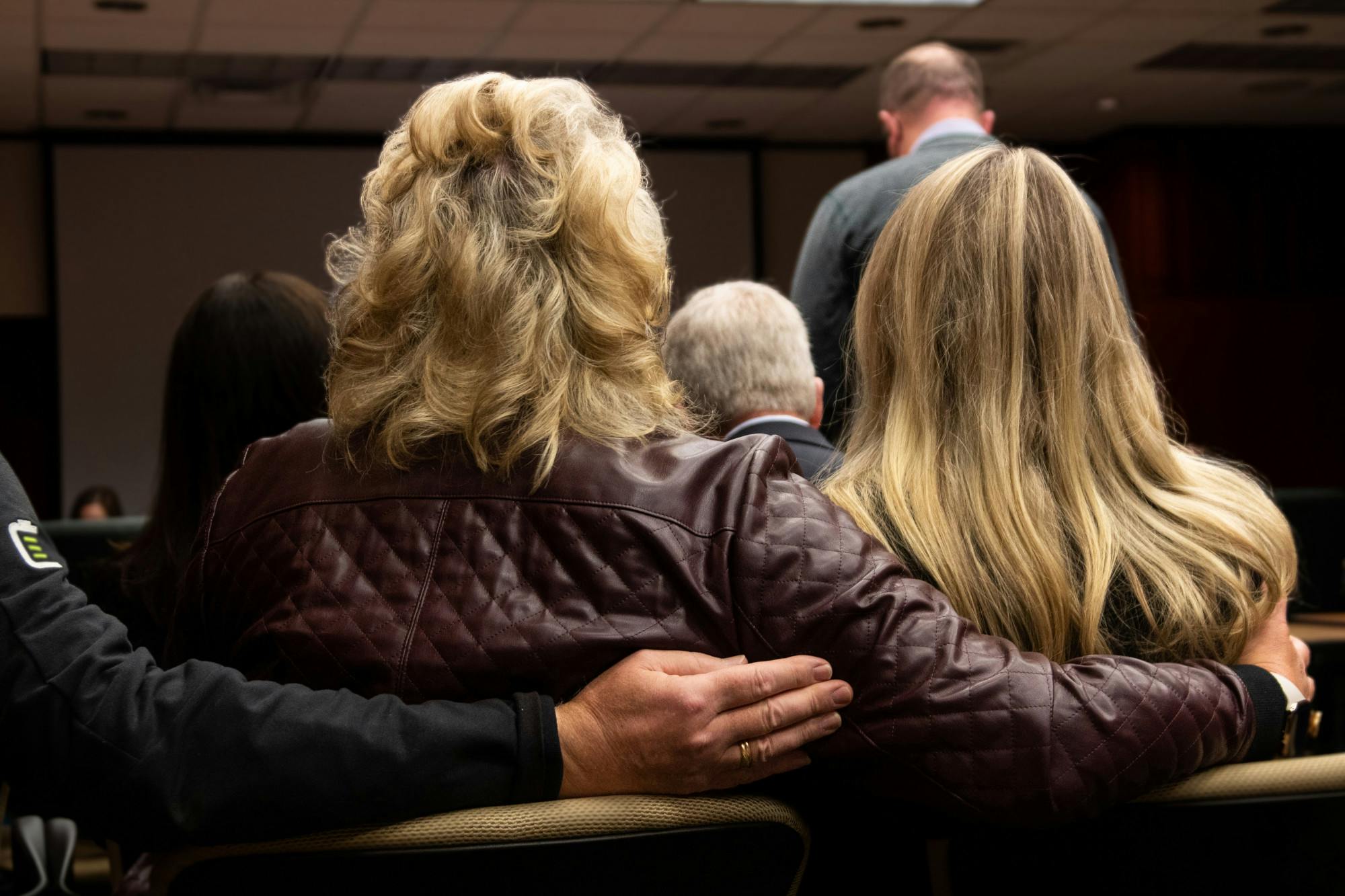 <p>Julia Lower&#x27;s family comforts her after her testimony in front of the Board of Trustees at their meeting on Friday, Dec. 17, 2021. Lower confronted the board for the university&#x27;s lack of resources and protection for survivors. &quot;Mandatory reporters revealed to me that they make students aware of the consequences of reporting, knowing that the trauma of seeking justice is often worse than the RVSM case itself,&quot; she said. </p>