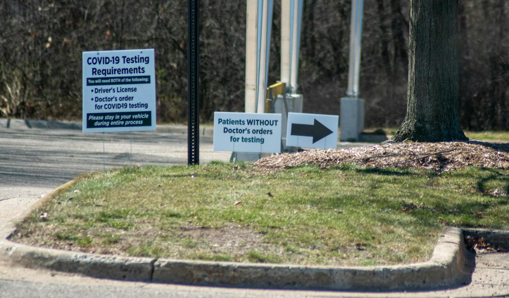 <p>Signs listing steps for Michigan State University COVID-19 drive-through patients to follow posted at a testing site on April 2, 2020.</p>