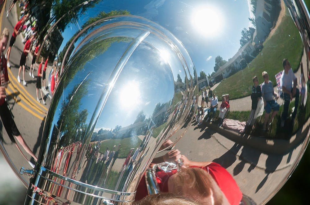 	<p>Spectators watch as members of the St. Johns Redwing Marching Band pass by at the start of the Mint Festival Parade Aug. 10, 2013, near St. Johns City Park. The hourlong parade kicked off the start of the day&#8217;s festivities and featured many different organizations from the area.  Danyelle Morrow/The State News</p>