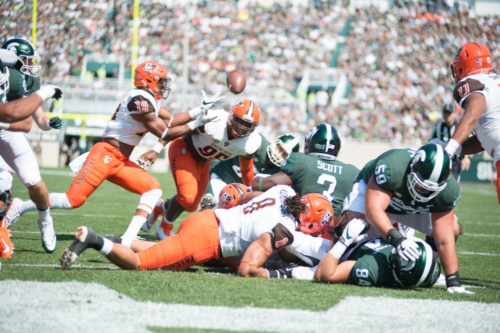 <p>Junior running back LJ Scott (3) fumbles the ball during the game against Bowling Green on Sep. 2, 2017, at Spartan Stadium. The Spartans defeated the Falcons, 35-10.</p>