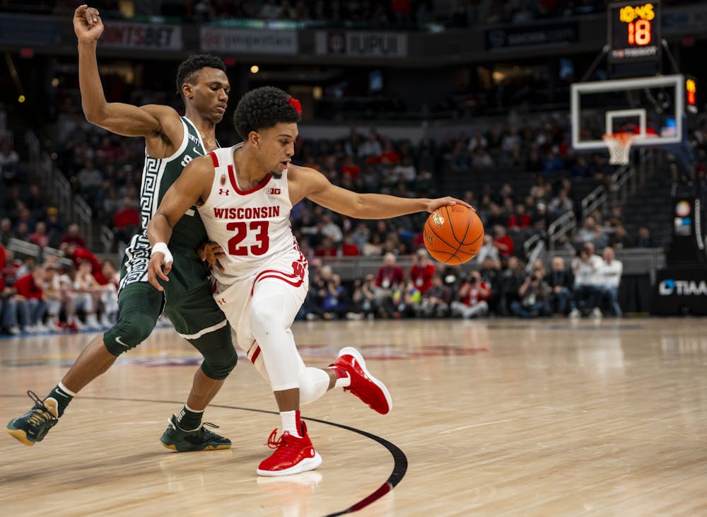 <p>Junior guard Tyson Walker (2) blocks Wisconsin&#x27;s freshman guard Chucky Hepburn (23) as he makes his way to the hoop in Michigan State&#x27;s game against the Badgers at Gainbridge Fieldhouse in Indianapolis, Indiana. Shot on March 11, 2022. </p>
