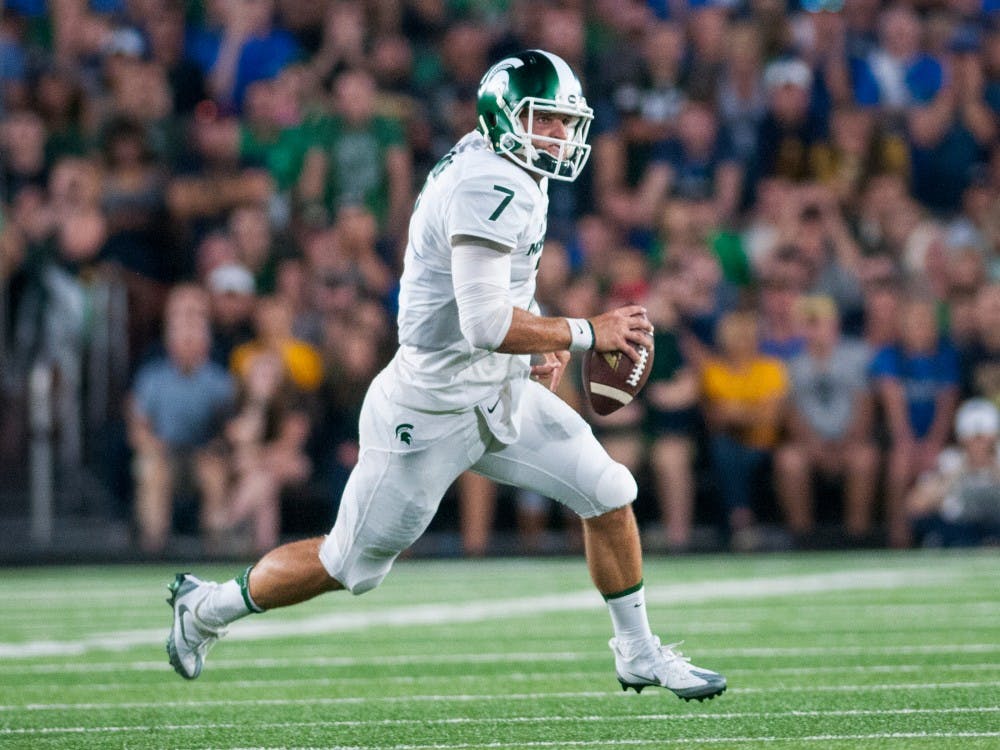 Senior quarterback Tyler O'Connor (7) runs down the field during the game against Notre Dame on Sept. 17, 2016 at Notre Dame Stadium in South Bend, Ind. The Spartans defeated the Fighting Irish, 36-28.