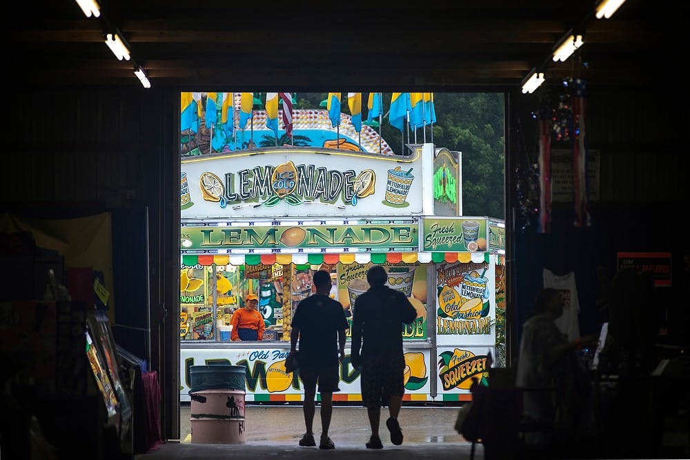 	<p>The weather on July 31, 2013 dampened the turnout at the 159th annual Ingham County Fair in Mason, Mich. The six-day event features various livestock and sports shows, as well as amusement facilities. Justin Wan/The State News</p>