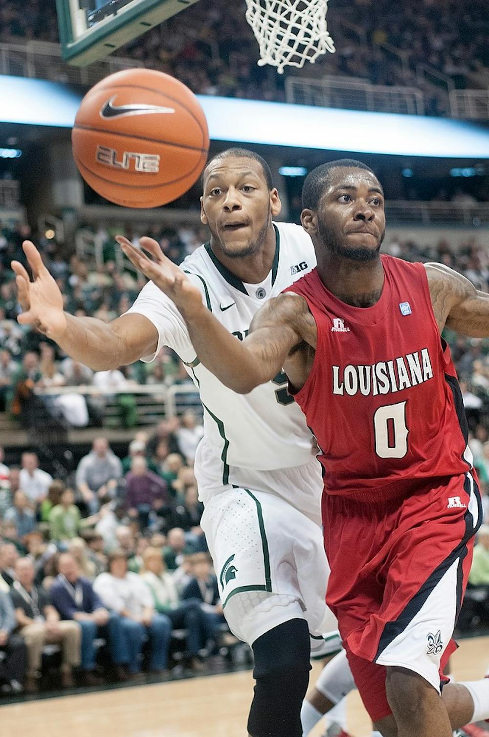 	<p>Junior center Adreian Payne attempts to knock the ball away from Louisiana-Lafayette&#8217;s guard Bryant Mbamalu on Nov. 25, 2012, at Breslin Center. The Spartans beat the Ragin&#8217; Cajuns, 63-60. Natalie Kolb/The State News</p>