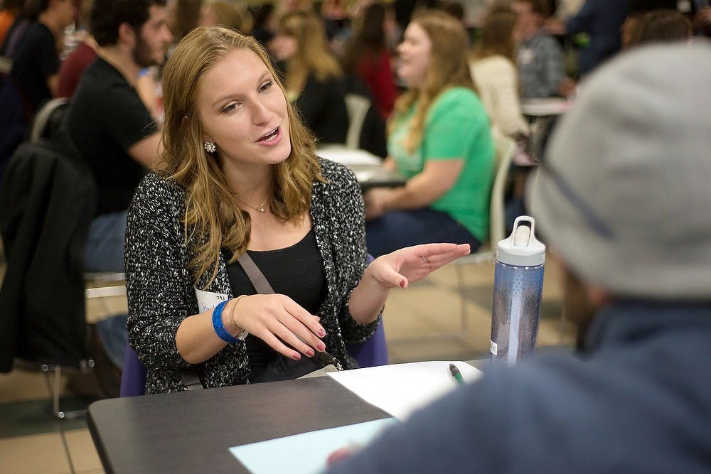 <p>General management freshman Jordan Kilinski converses with human biology sophomore John Jarad on Jan. 24, 2015, during the speed dating event at the International Center, 427 N Shaw Lane in East Lansing. Kilinski went to the event with a friend to meet new people and have fun. Emily Nagle/The State News</p>