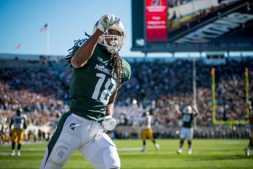 <p>Junior wide receiver Felton Davis III (18) celebrates after scoring a touchdown during the game against Iowa on Sept. 30, 2017, at Spartan Stadium. The Spartans defeated the Hawkeyes, 17-10.</p>