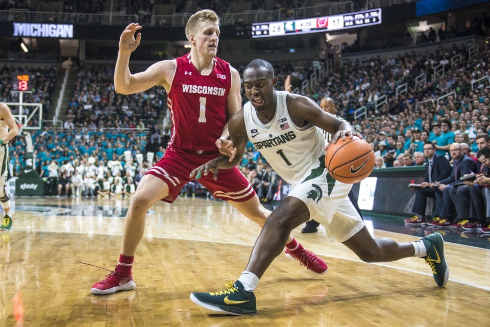 Sophomore guard Joshua Langford (1) handles the ball as he is covered by Wisconsin guard Brevin Pritzl (1) during the men's basketball game against Wisconsin on Jan. 26, 2018 at Breslin Center. (Nic Antaya | The State News)