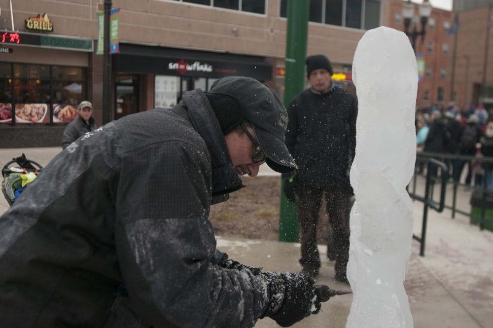 Ice sculptor Scott Miller works on a piece during Winter Glow on Dec. 3, 2016 at Ann St. Plaza. In addition to live sculpting, the event featured horse and carriage rides, live music and booths from different local businesses.
STATE NEWS FILE PHOTO