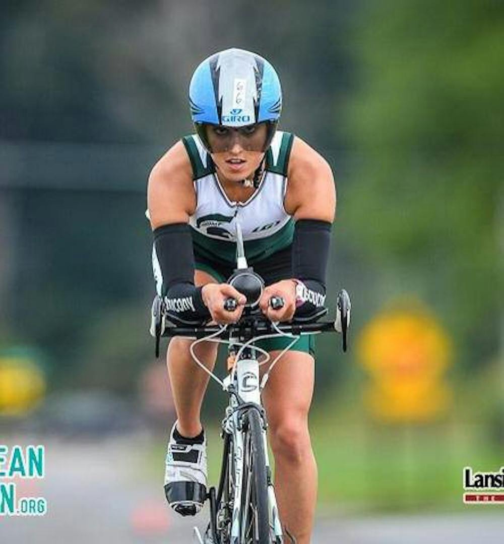 <p>Elaine Sheikh competes in the bike portion of a triathlon. Triathlon consists of swimming, biking and running. Photo Courtesy of Elaine Sheikh.&nbsp;</p>