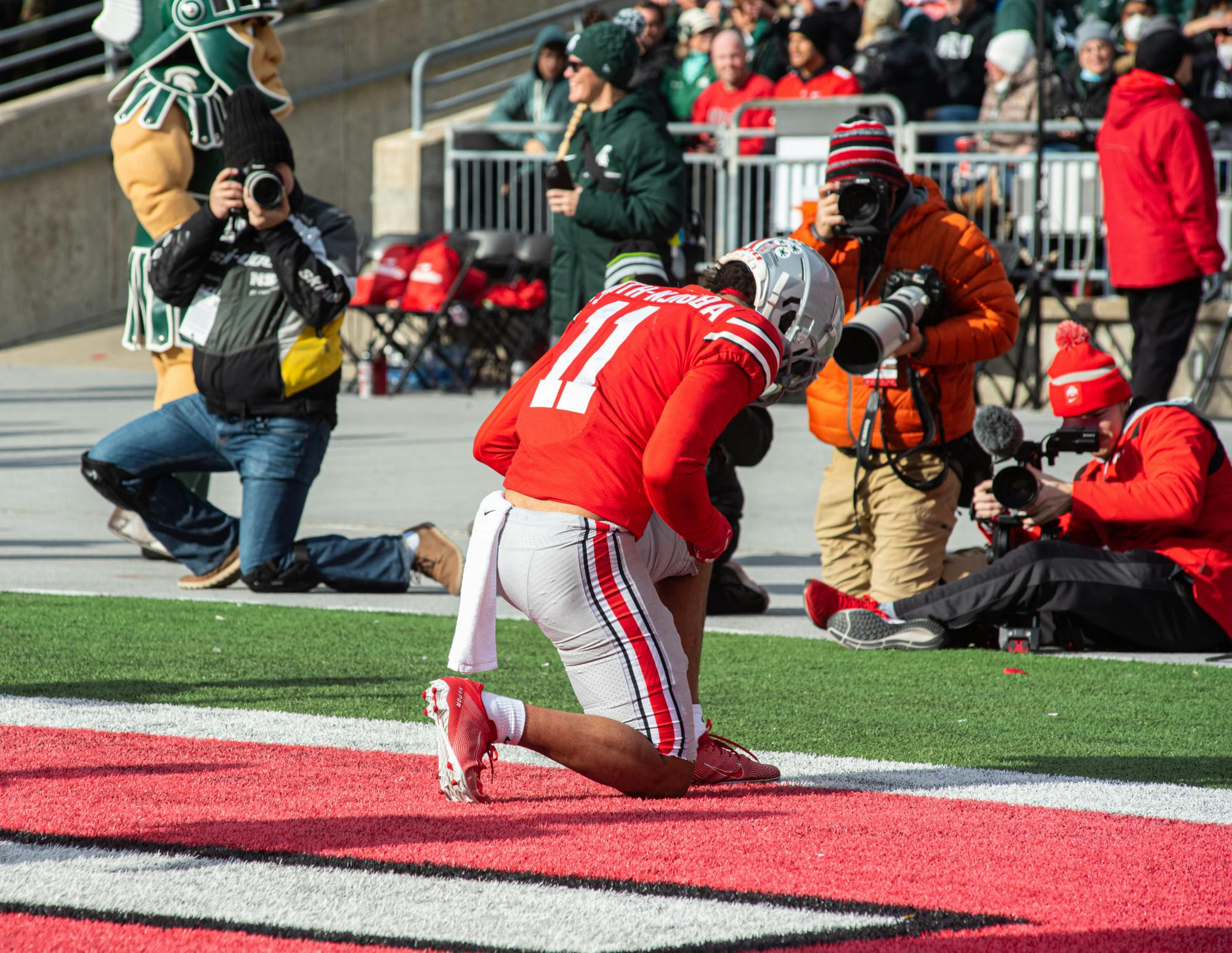 <p>Ohio State&#x27;s Jaxon Smith-Njigba (11) kneals in the endzone after completing a touchdown on Nov. 20, 2021.</p>