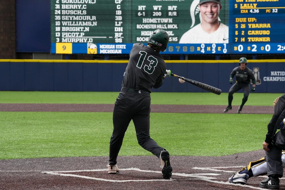 <p>Michigan State Sophomore Parker Picot (13) hits a base hit against Michigan on April 26, 2025. The Spartans lost to the Wolverines in the second game 9-2.</p>