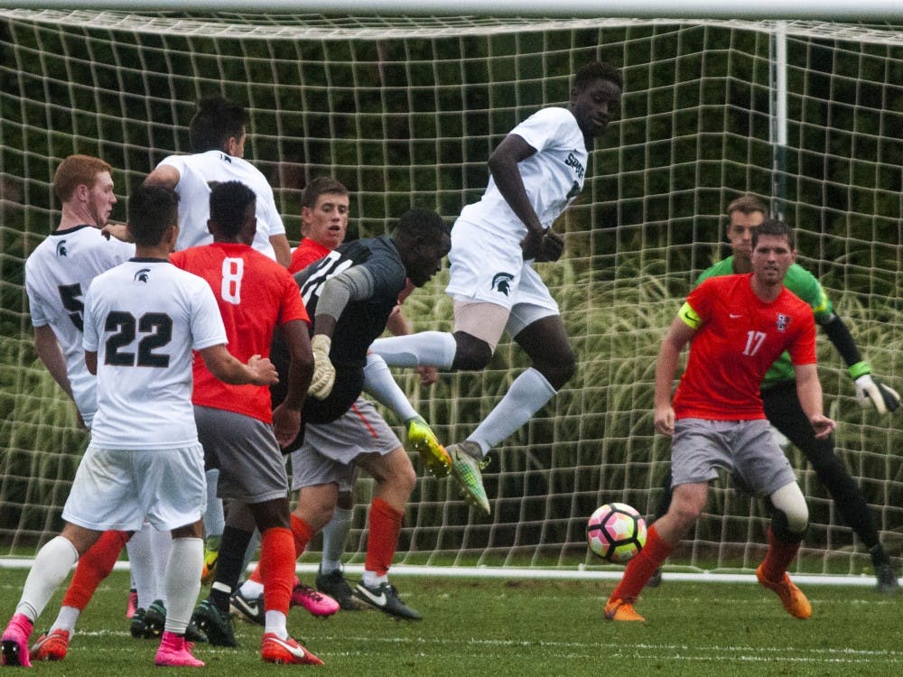 Freshman defenseman Michael Wetungu (17) jumps to block a shot during the game against Bowling Green on Sept. 28, 2016.  The Spartans defeated the Falcons, 1-0.  