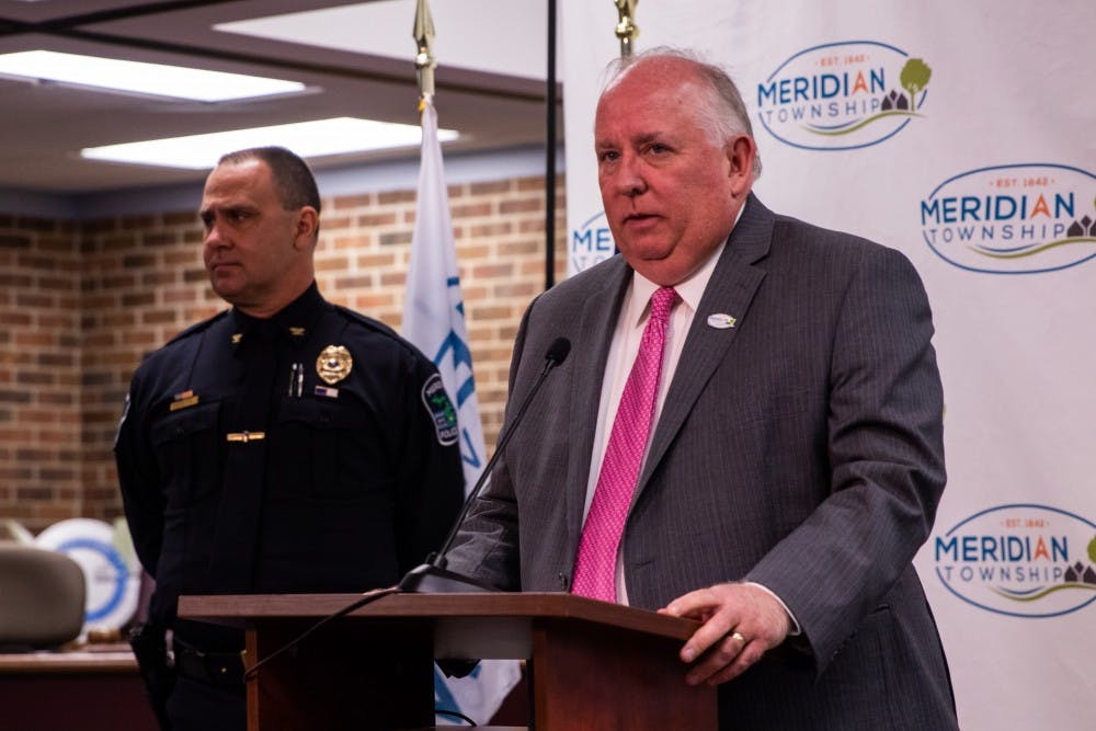 <p>Meridian Township Manager Frank Walsh (right) speaks at a press conference in Meridian Township Town Hall, accompanied by Meridian Township Police Chief Ken Plaga (left) March 26, 2019.</p>