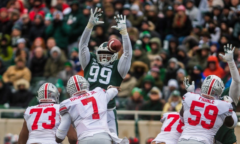 Junior defensive tackle Raequan Williams (99) tries to block a pass during the game against Ohio State at Spartan Stadium on Nov. 10, 2018. The Spartans fell to the Buckeyes, 26-6.