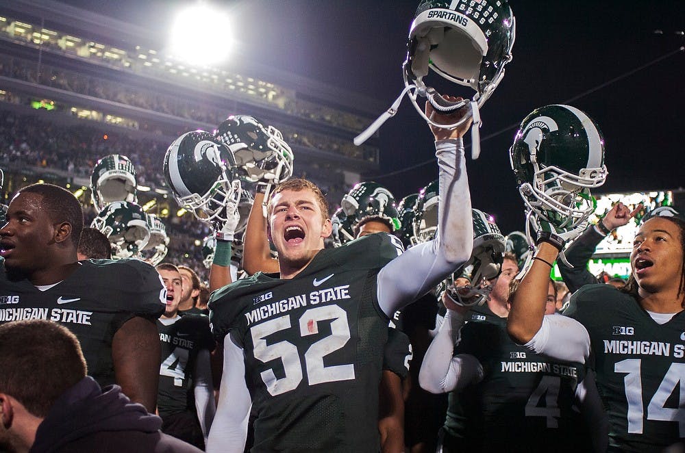 	<p>Sophomore long snapper Taybor Pepper sings the fight song after a game against Michigan on Nov. 2, 2013, at Spartan Stadium. The Spartans defeated the Wolverines, 29-6. Georgina De Moya/The State News</p>