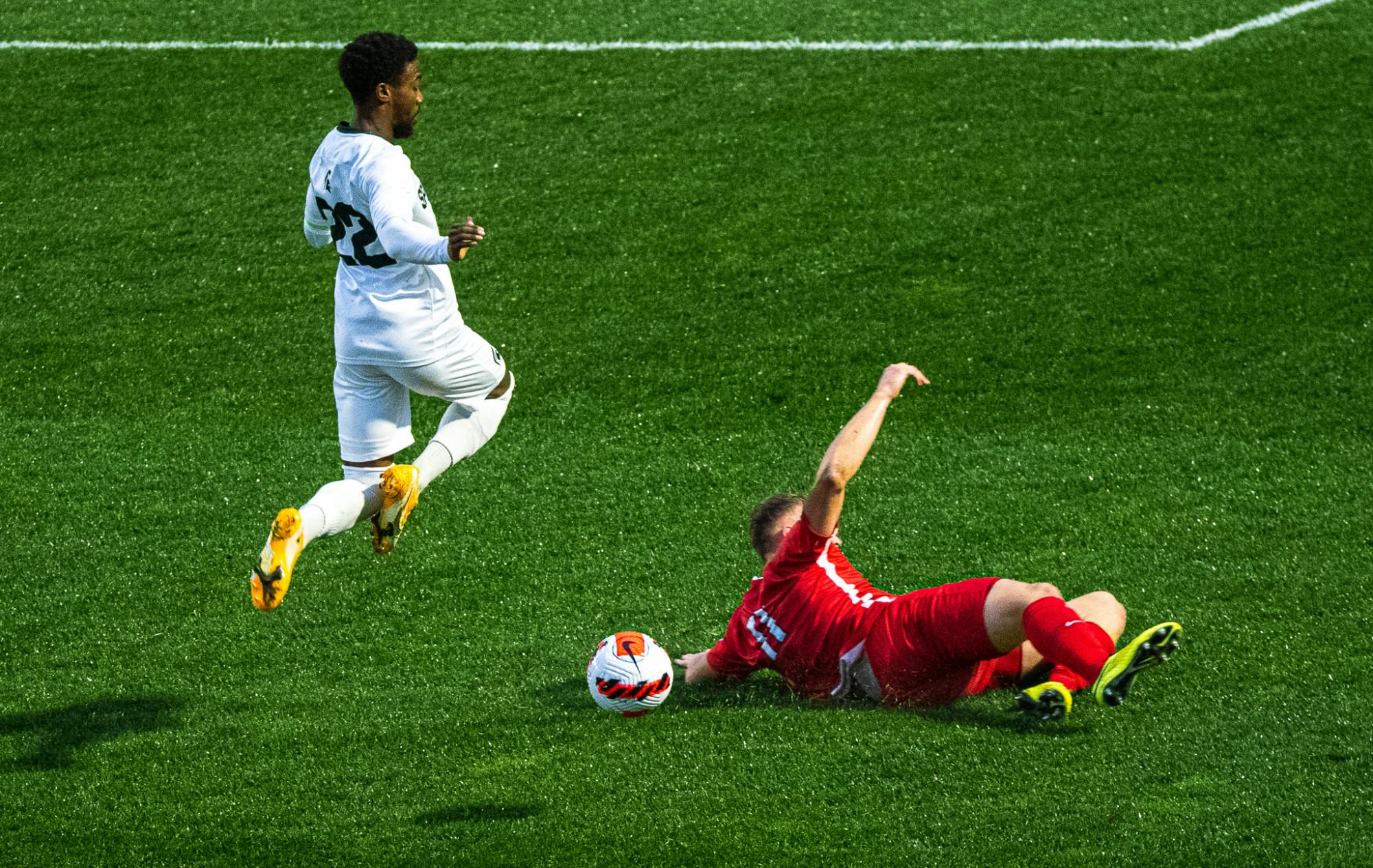 <p>Redshirt junior Will Perkins jumps to avoid a sliding defender. Michigan State men&#x27;s soccer team defeated Duquesne 1-0 on Sept. 11, 2021 in East Lansing.</p>