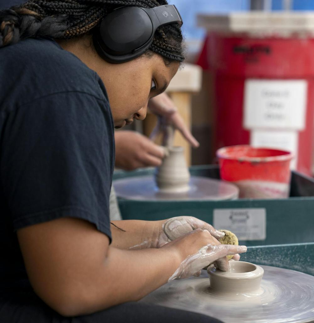 <p>History freshman Celia Embry focuses intensely on a bowl she is creating on the ceramics wheel during Clay Club in the Kresge Art Center on Oct. 14, 2024.</p>
