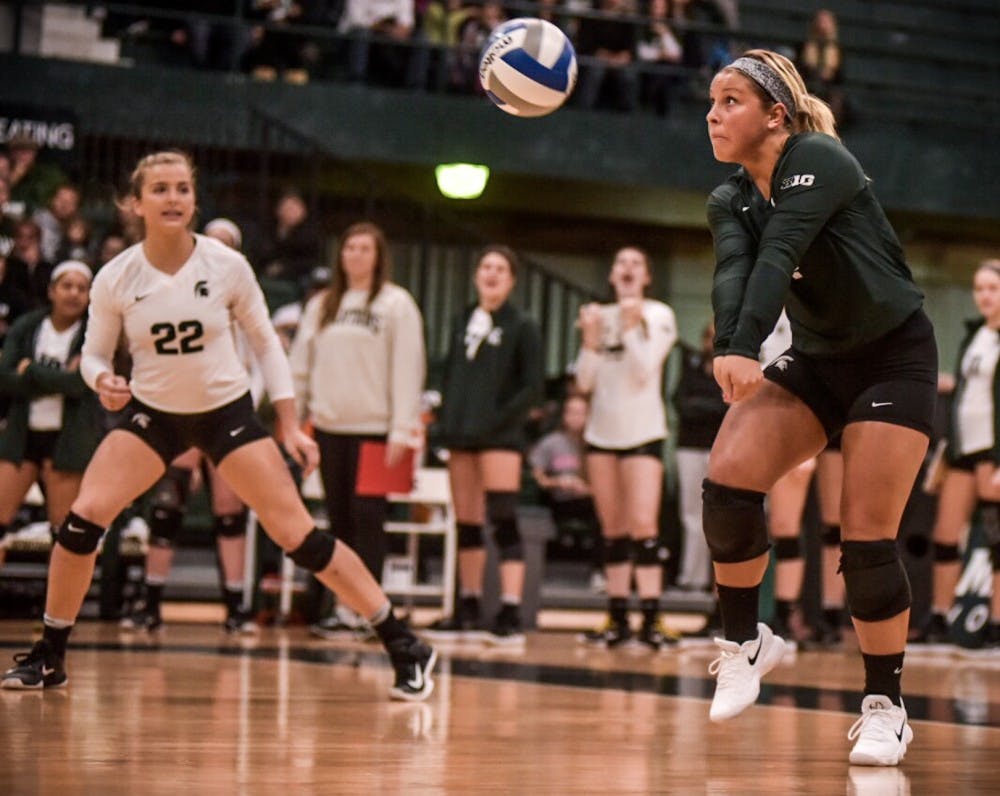 Freshman defensive specialist and libero Jamye Cox (4) hits the ball during the game against Northwestern on Nov. 11, 2017 at Jenison Fieldhouse. The Spartans defeated the Wildcats, 3-0. 