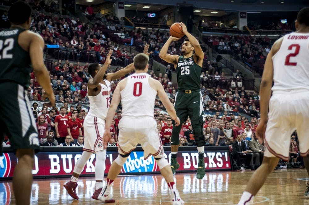 Sophomore forward Kenny Goins (25) shoots over Ohio State guard JaQuan Lyle (13) during the first half of the men's basketball game against Ohio State on Jan. 15, 2017 at the Jerome Schottenstein Center. The Spartans trail the Buckeyes, 33-36 at the half.