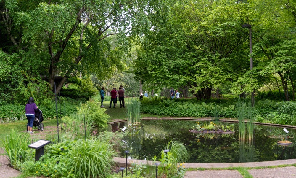 <p>Lansing residents explore the W.J. Beal Botanical Gardens during the 25th anniversary of Lansing’s Be a Tourist in Your Own Town on June 1, 2019.</p>