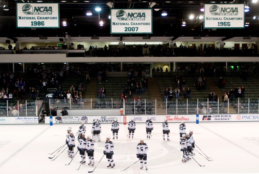 The Spartans team celebrates on the ice after defeating the Colonials, 5-2, on Friday night at Munn Ice Arena. Justin Wan/The State News