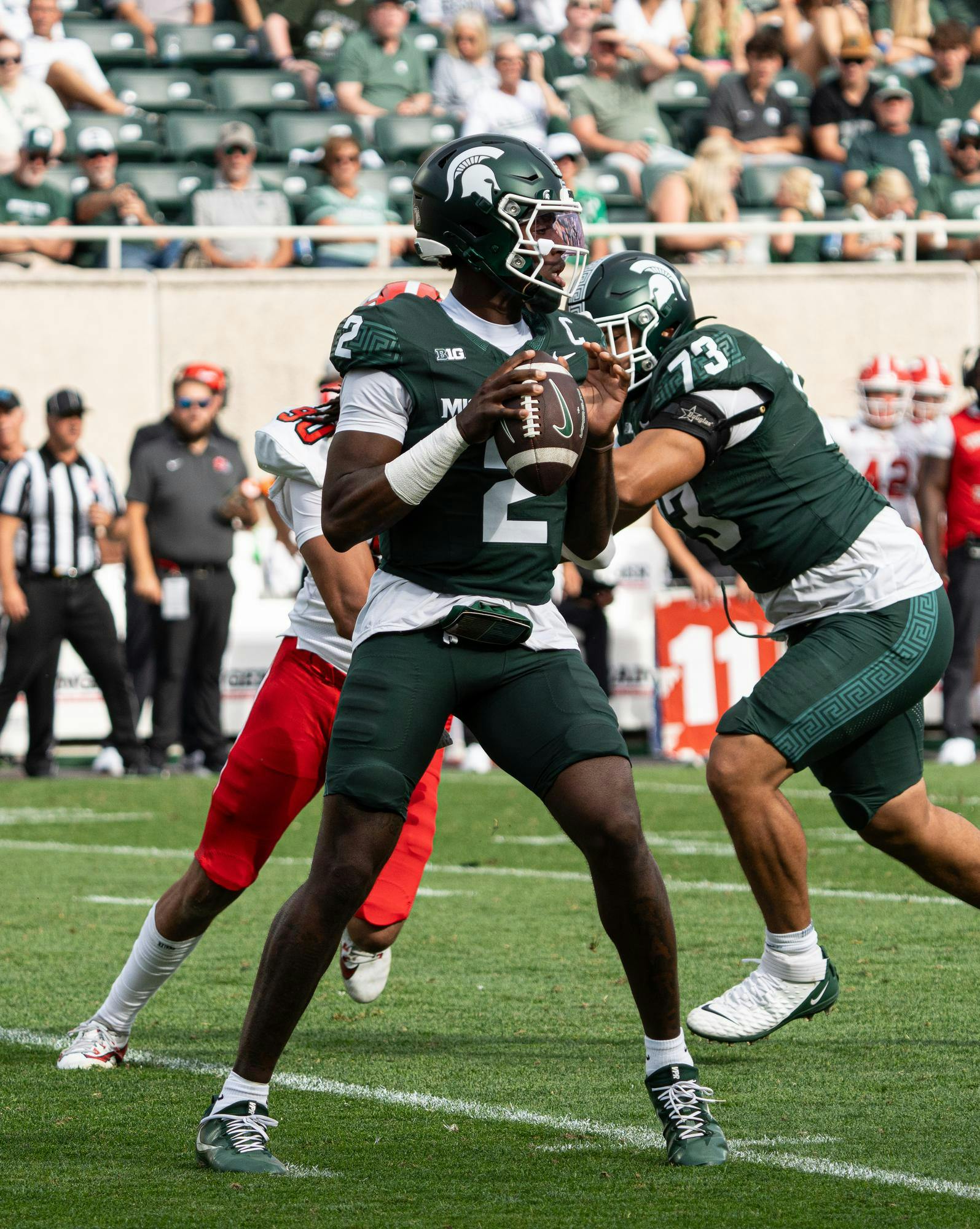 <p>MSU left tackle Rustin Young (73) protects quarterback Aidan Chiles (2) as he looks for an open receiver versus Youngstown State at Spartan Stadium in East Lansing, Michigan on Sept. 13, 2025.</p>