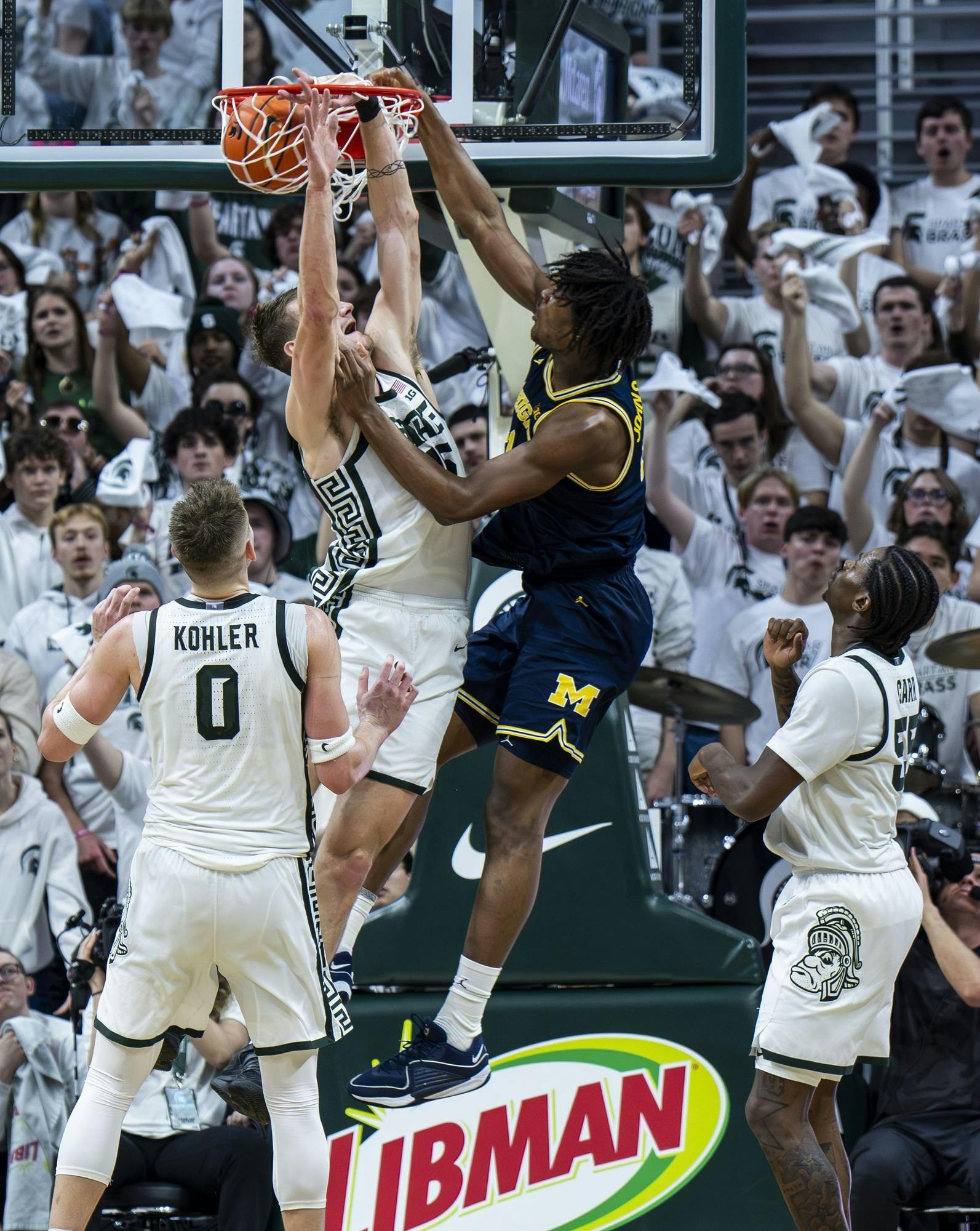 MSU senior center Carson Cooper (15) dunks the ball in the Breslin Student Events Center on Jan. 30, 2026. UM defeated MSU 83-71. 