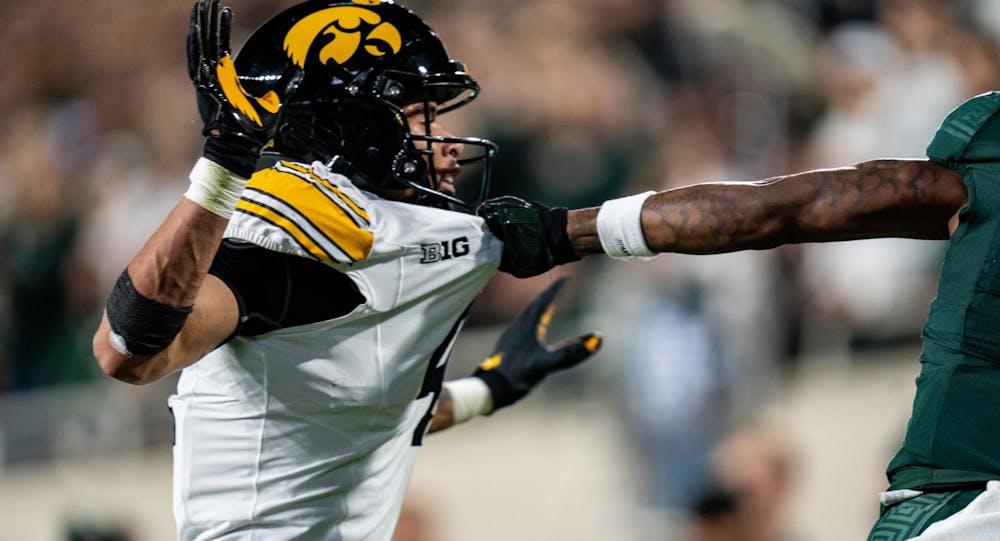 <p>Michigan State University redshirt freshman wide receiver Aziah Johnson (11) pulls University of Iowa sophomore defensive back Koen Entringer’s (4) jersey during their matchup at Spartan Stadium on Oct. 19, 2024. The Spartans beat the Hawkeyes 32-20, breaking a three-game losing streak.</p>