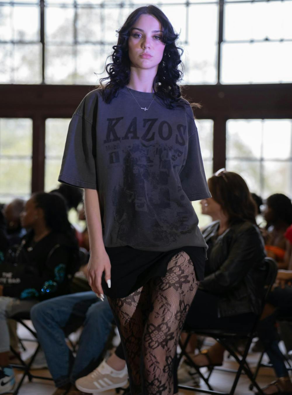 <p>A model poses in a shirt designed by Kazos Designs, a luxury streetwear clothing line.</p>